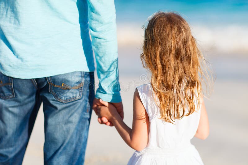 Adorable little girl holding her father hand. Adorable little girl holding her father hand