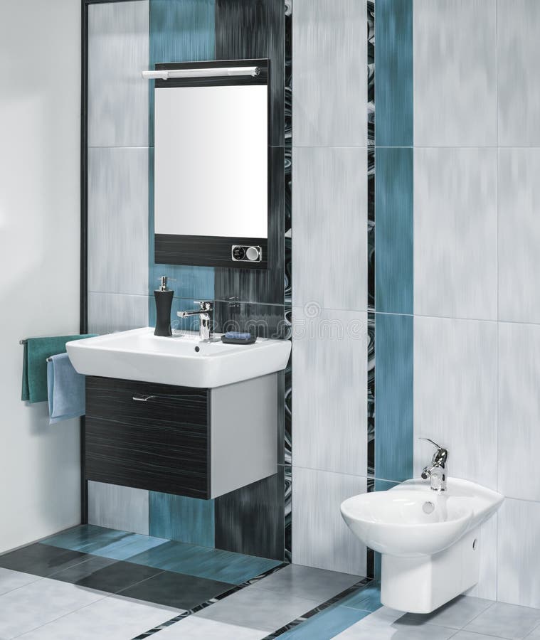 Detail of a luxurious bathroom interior with miror and sink with accessories with tiles in three colors. Detail of a luxurious bathroom interior with miror and sink with accessories with tiles in three colors