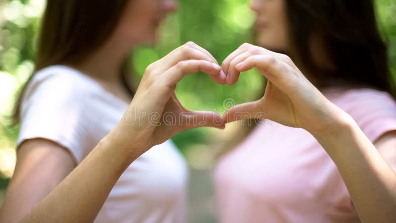 Λεσβιακό ζεύγος που κατασκευάζει την καρδιά με τα χέρια, ανοικτή σχέση στην αγάπη ίδιος-φύλων στοκ εικόνα Λεσβιακό ζεύγος που κατασκευάζει την καρδιά με τα χέρια, ανοικτή σχέση στην αγάπη ίδιος-φύλων στοκ εικόνα