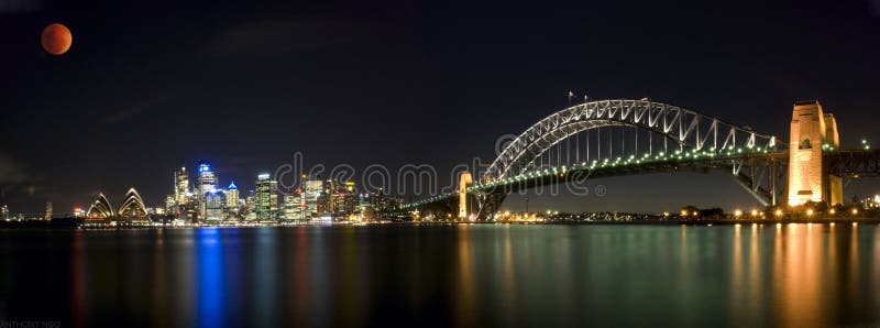 Panoramic view of Lunar eclipse, orange red moon sci-fi scientific scene star war alike over Sydney Harbour Sky Line Panorama At Night, NSW, Australia, Oceania. The Sydney harbour bridge and sydney opera house sparkling in the night. Colourful surface. Night scene, panorama. Panoramic view of Lunar eclipse, orange red moon sci-fi scientific scene star war alike over Sydney Harbour Sky Line Panorama At Night, NSW, Australia, Oceania. The Sydney harbour bridge and sydney opera house sparkling in the night. Colourful surface. Night scene, panorama