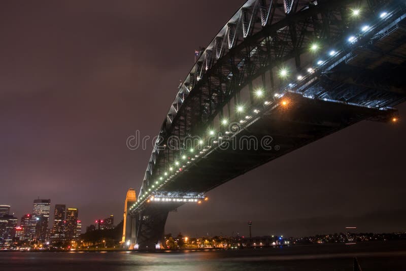 Sydney Harbour Bridge under lights on a storm night. Sydney Harbour Bridge under lights on a storm night.