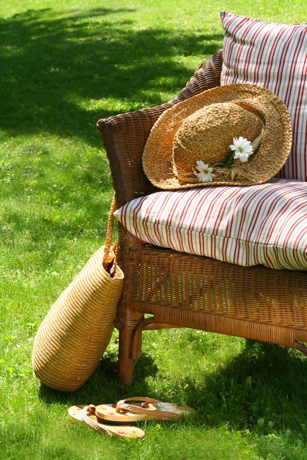 Grass lawn with a wicker chair waiting for someone to relax on a hot summer's day. Grass lawn with a wicker chair waiting for someone to relax on a hot summer's day