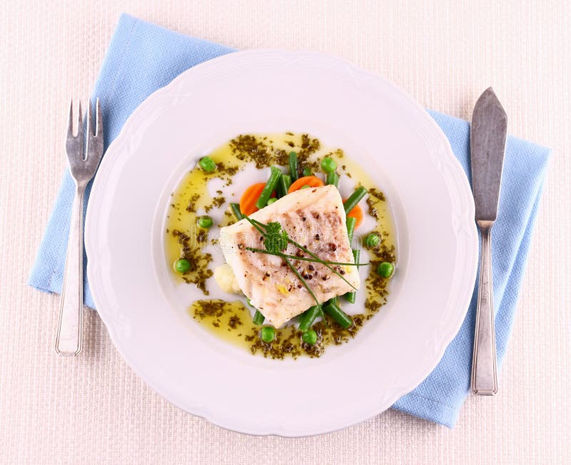 Cod Fillet with green beans, peas, parsley, olive oil, top view. Cod Fillet with green beans, peas, parsley, olive oil, top view