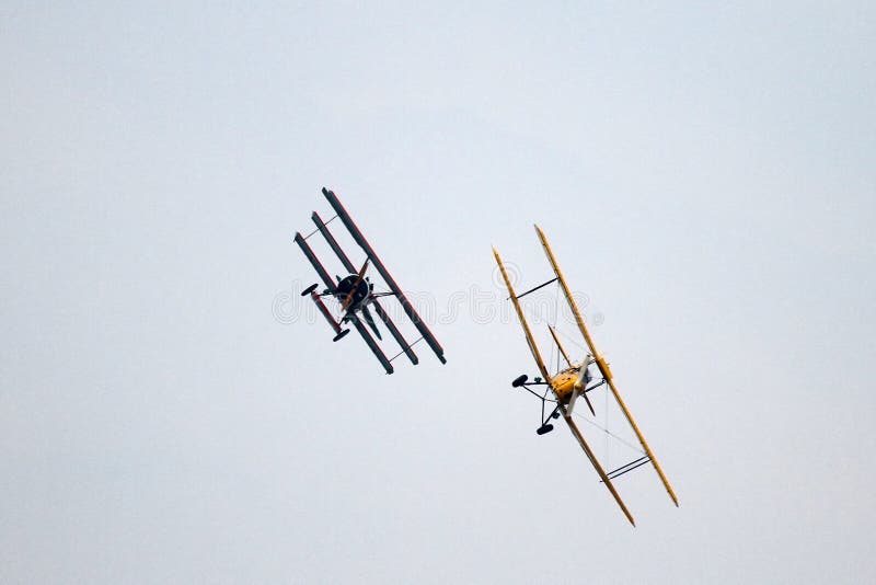 Commemorating 100 years of the first flight school in Italy, La Comina, near Pordenone. Flight demonstration of historic aircraft. Simulated air battle between two aircraft. Yellow: De Havilland DH 82 Tiger Moth is is a 1930s biplane designed by Geoffrey de Havilland and was operated by the Royal Air Force and others as a primary trainer. The Tiger Moth remained in service with the RAF until 1952 when many of the surplus aircraft entered civil operation. Red: Fokker DR.I Dreidecker (triplane) was a World War I fighter aircraft built by Fokker-Flugzeugwerke. The Dr.I saw widespread service in the spring of 1918. It became renowned as the aircraft in which Manfred von Richthofen gained his last 20 victories, and in which he was killed on 21 April 1918. Commemorating 100 years of the first flight school in Italy, La Comina, near Pordenone. Flight demonstration of historic aircraft. Simulated air battle between two aircraft. Yellow: De Havilland DH 82 Tiger Moth is is a 1930s biplane designed by Geoffrey de Havilland and was operated by the Royal Air Force and others as a primary trainer. The Tiger Moth remained in service with the RAF until 1952 when many of the surplus aircraft entered civil operation. Red: Fokker DR.I Dreidecker (triplane) was a World War I fighter aircraft built by Fokker-Flugzeugwerke. The Dr.I saw widespread service in the spring of 1918. It became renowned as the aircraft in which Manfred von Richthofen gained his last 20 victories, and in which he was killed on 21 April 1918.