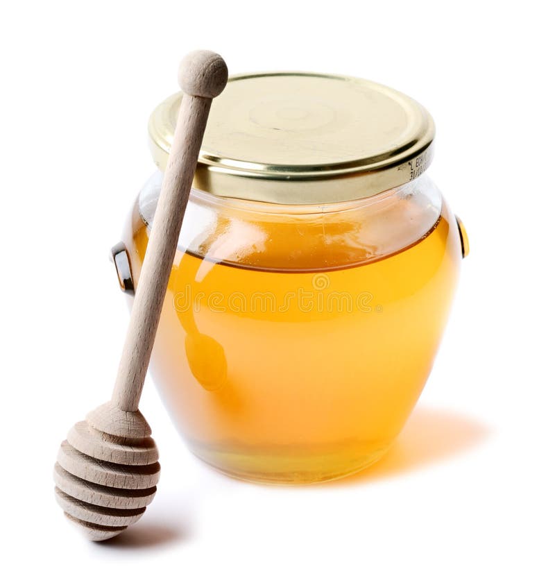 A jar of honey isolated on white background with wood stick. A jar of honey isolated on white background with wood stick