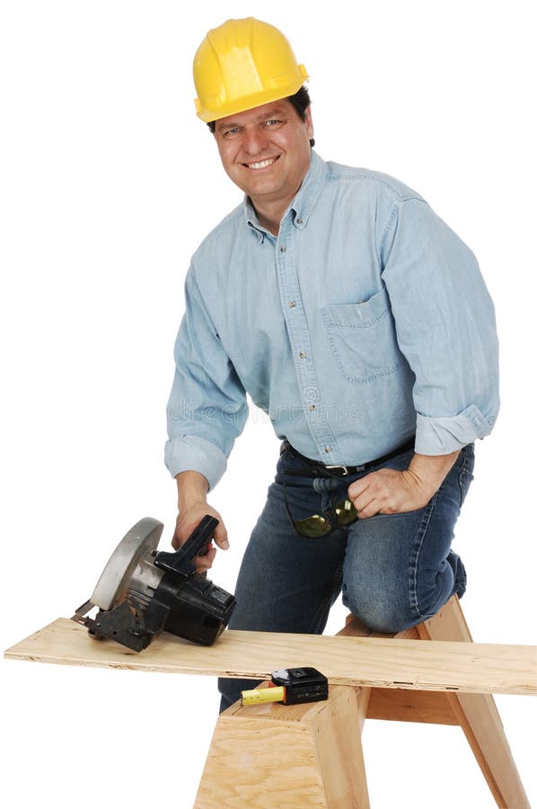 Medium shot of a carpenter wearing a hard hat and demins about to cut a plank with a power saw. Shot on white background. Medium shot of a carpenter wearing a hard hat and demins about to cut a plank with a power saw. Shot on white background