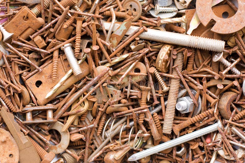 An assortment of rusty metal fasteners and nails. An assortment of rusty metal fasteners and nails.