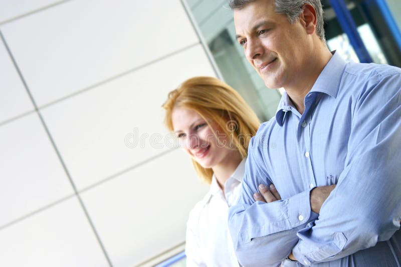 Two colleagues looking forward suggesting teamwork and strong business connections. Horizontal orientation. Two colleagues looking forward suggesting teamwork and strong business connections. Horizontal orientation.