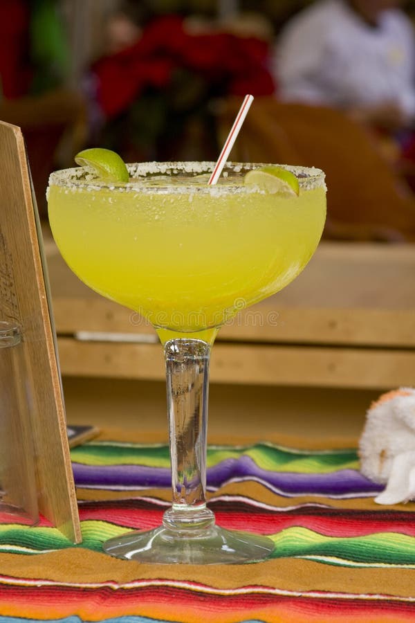 Closeup of margarita drink atop a mexican tablecloth. Closeup of margarita drink atop a mexican tablecloth