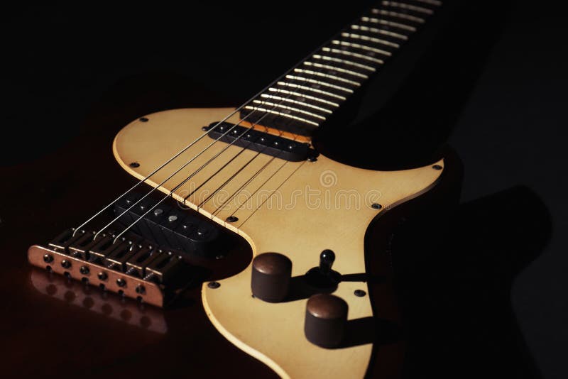 Electric guitar on black background, closeup. Musical instrument. Electric guitar on black background, closeup. Musical instrument