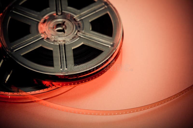 Red and black film reel concept background. Focus on film. Movie industry. Red and black film reel concept background. Focus on film. Movie industry.