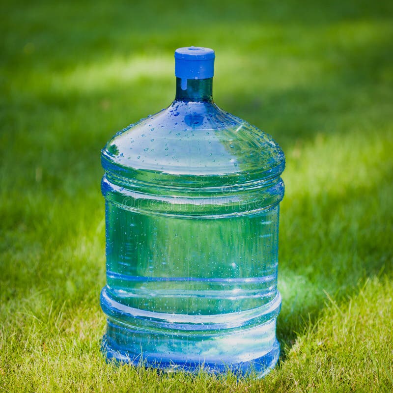 Water big bottle on green grass background. Water big bottle on green grass background
