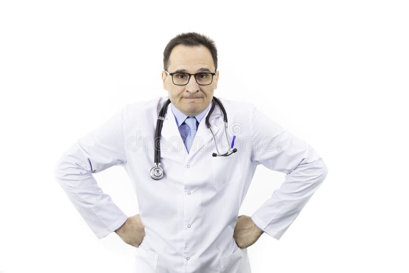 Middle-aged handsome doctor in white coat, glasses and stethoscope looking at camera with anger face with hands on sides, isolated white background. healthcare, negative emotions and medicine concept. Middle-aged handsome doctor in white coat, glasses and stethoscope looking at camera with anger face with hands on sides, isolated white background. healthcare, negative emotions and medicine concept