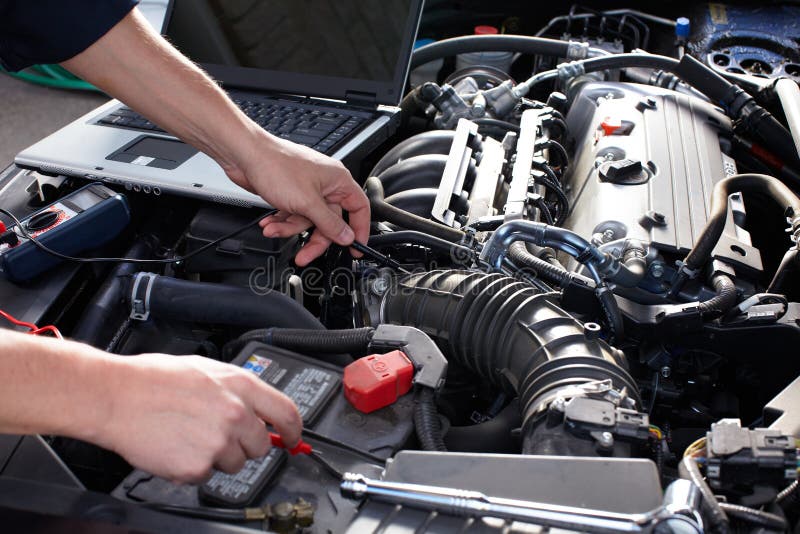 Professional car mechanic working in auto repair service. Professional car mechanic working in auto repair service.