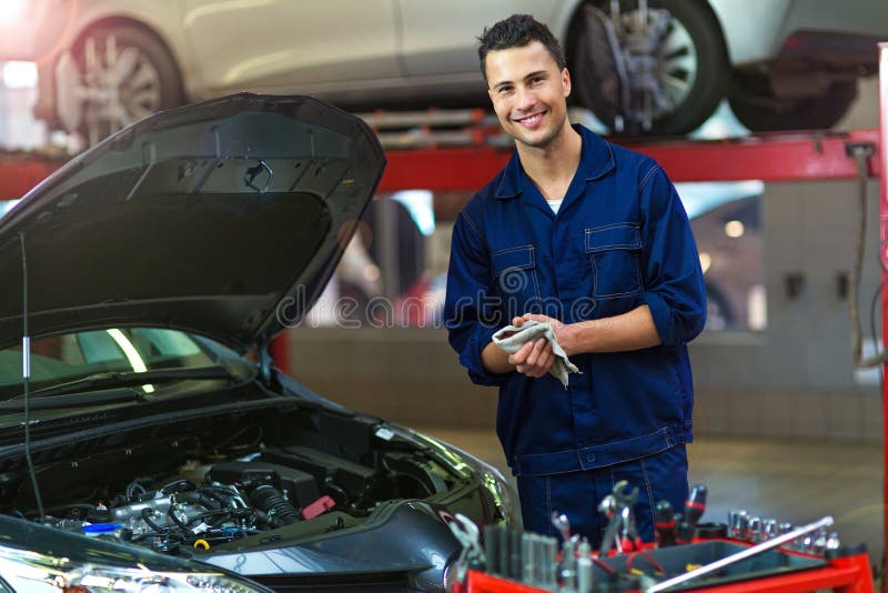 Mechanic working on car in auto repair shop. Mechanic working on car in auto repair shop