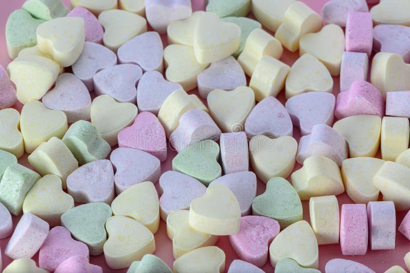 small heart-shaped candies on a pink background 5. small heart-shaped candies on a pink background 5