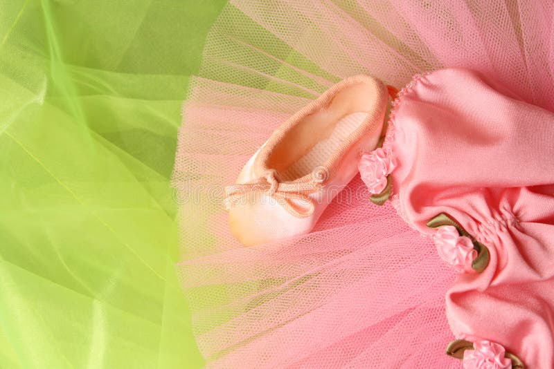 Pink Ballet costume and miniature shoe on a rustic background. Pink Ballet costume and miniature shoe on a rustic background