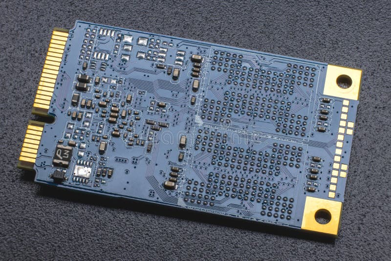 M.2 format SSD module. Close-up of an electronic board with gold-plated contacts and SMD components. M.2 format SSD module. Close-up of an electronic board with gold-plated contacts and SMD components.