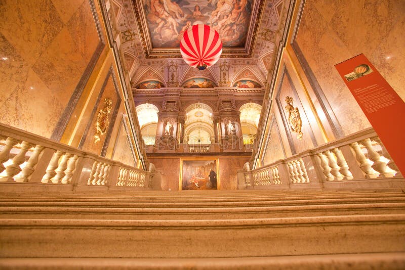 Cream colored, light flushed marble staircase of a museum with view of a hydrogen balloon. Cream colored, light flushed marble staircase of a museum with view of a hydrogen balloon