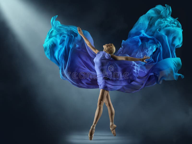 Ballerina in Purple Chiffon Dress on Stage Light Beam. Ballet Dancer in Silk Fantasy Blue Gown. Woman dancing with flying Cyan Fabric as Wings over Dark Background with Light Beam. Ballerina in Purple Chiffon Dress on Stage Light Beam. Ballet Dancer in Silk Fantasy Blue Gown. Woman dancing with flying Cyan Fabric as Wings over Dark Background with Light Beam