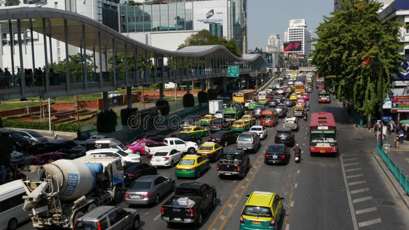 BANGKOK, THAILAND - 18 DECEMBER, 2018: Cars on busy city street. Many modern cars and buses riding on busy street on sunny day. traffic congestion, overpopulation, environmental problems in cities. BANGKOK, THAILAND - 18 DECEMBER, 2018: Cars on busy city street. Many modern cars and buses riding on busy street on sunny day. traffic congestion, overpopulation, environmental problems in cities