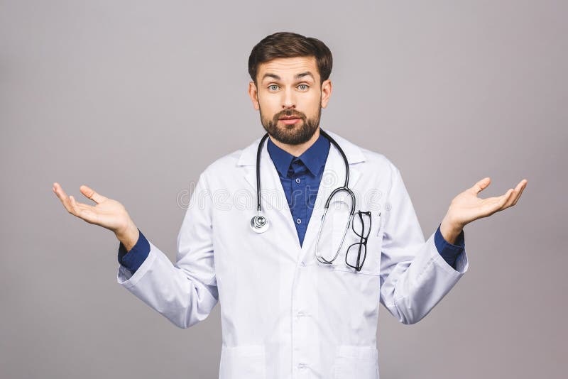 Confused serious male doctor looking at you with stethoscope around his neck, serious face isolated on grey background. Confused serious male doctor looking at you with stethoscope around his neck, serious face isolated on grey background