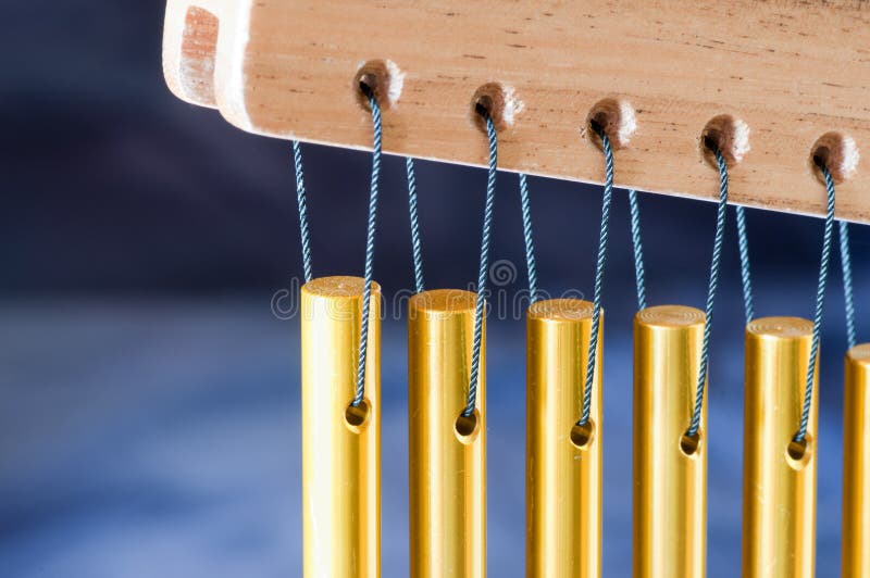 Close up of bar chimes on a blue background. Close up of bar chimes on a blue background