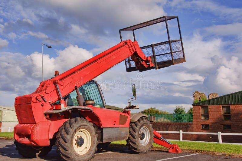 Red mobile cherry picker into blue sky. Red mobile cherry picker into blue sky