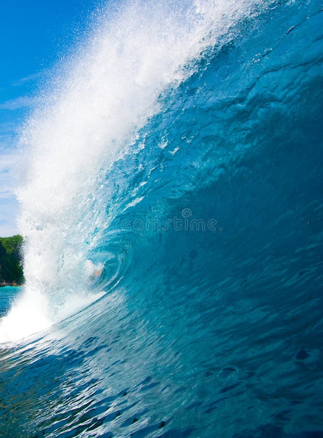 Blue Surfing Wave Breaks in Ocean. Blue Surfing Wave Breaks in Ocean
