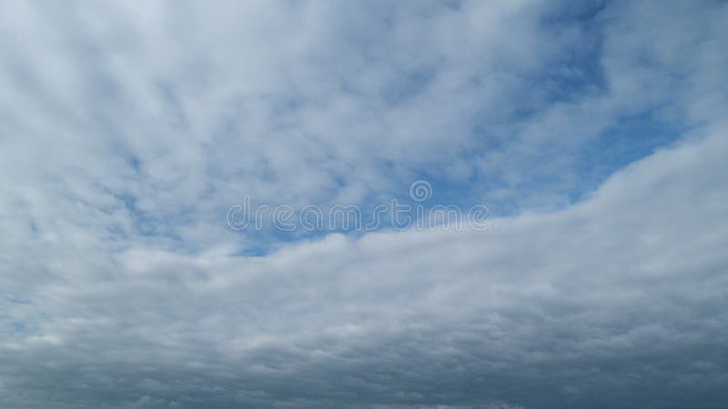 Timelapse. Blue sky background with cirrocumulus clouds. Sunlight and sun ray at sunshine on sunset. Timelapse. Blue sky background with cirrocumulus clouds. Sunlight and sun ray at sunshine on sunset.