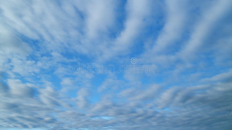 Timelapse. Blue sky background with cirrocumulus clouds. Sunlight and sun ray at sunshine on sunset. Timelapse. Blue sky background with cirrocumulus clouds. Sunlight and sun ray at sunshine on sunset.