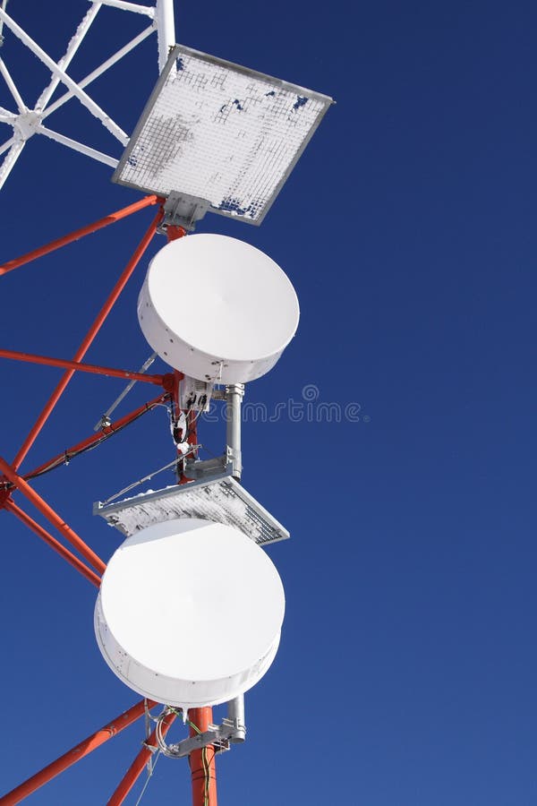 Detail of a frozen GSM antenna with blue sky as background. Detail of a frozen GSM antenna with blue sky as background