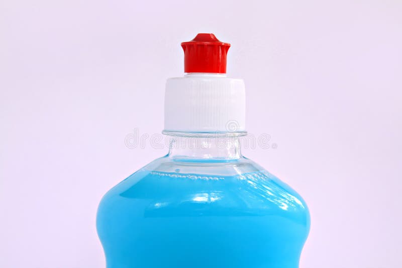 Blue liquid in bottle on lilac background. Blue liquid in bottle on lilac background