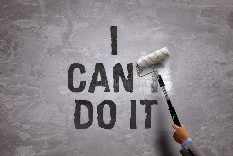 Changing the word can't to can by painting over and erasing part of it with a paint roller on a concrete wall in the phrase i can do it. Changing the word can't to can by painting over and erasing part of it with a paint roller on a concrete wall in the phrase i can do it