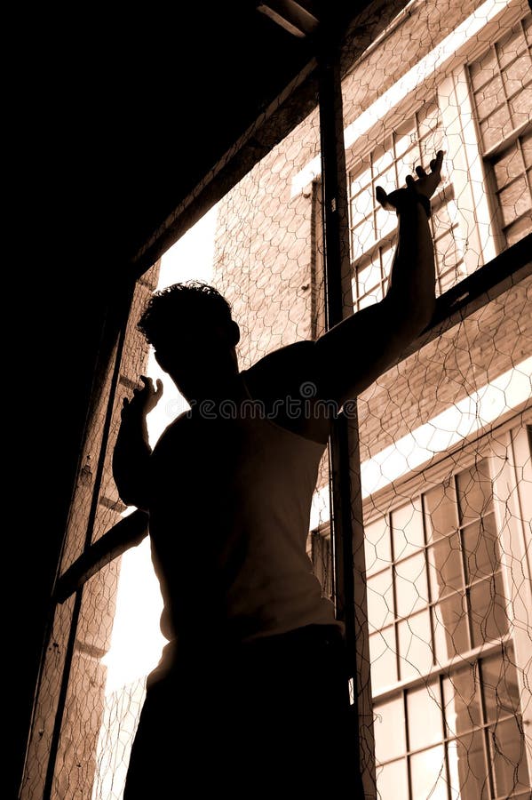 Sillouette of a male with curly hair in an urban window. Sillouette of a male with curly hair in an urban window