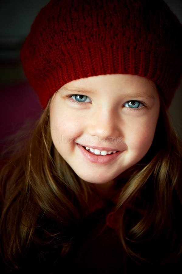 Baby 3 years old with blue eyes and white teeth in a red beret.Hair long. Baby 3 years old with blue eyes and white teeth in a red beret.Hair long