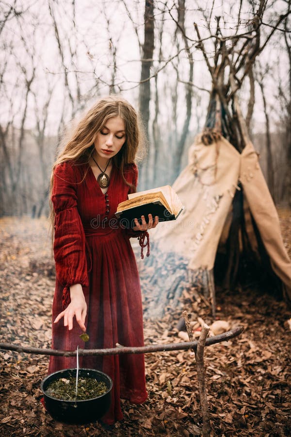 Young woman in red dress in the autumn forest. Young woman in red dress in the autumn forest