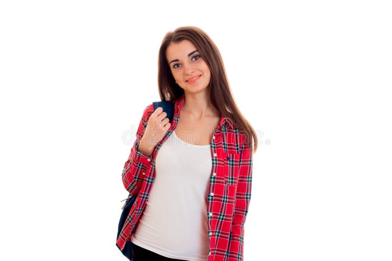 Νέα όμορφη γυναίκα σπουδαστών brunette με το μπλε σακίδιο πλάτης στον ώμο της που εξετάζει τη κάμερα και το χαμόγελο που απομονών στοκ φωτογραφίες με δικαίωμα ελεύθερης χρήσης Νέα όμορφη γυναίκα σπουδαστών brunette με το μπλε σακίδιο πλάτης στον ώμο της που εξετάζει τη κάμερα και το χαμόγελο που απομονών στοκ φωτογραφίες με δικαίωμα ελεύθερης χρήσης