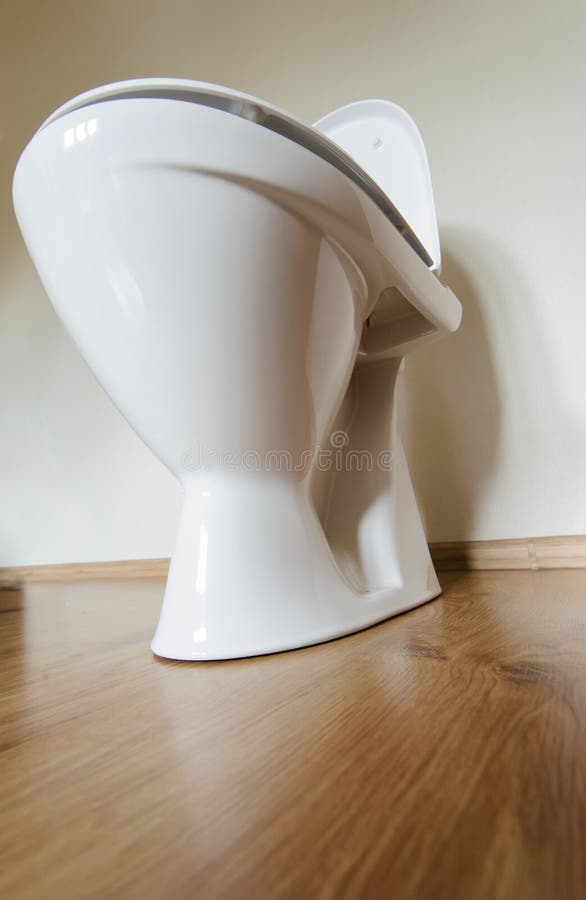 New ceramic toilet bowl indoors, wide angle, background, bath, bathroom, clean, closet, comfortable, design, domestic, equipment, facilities, floor, home, house, household, hygiene, interior, lavatory, lid, modern, object, one, porcelain, restroom, sanitary, seat, single, tank, tidy, utilities, view, washroom, wc, white. New ceramic toilet bowl indoors, wide angle, background, bath, bathroom, clean, closet, comfortable, design, domestic, equipment, facilities, floor, home, house, household, hygiene, interior, lavatory, lid, modern, object, one, porcelain, restroom, sanitary, seat, single, tank, tidy, utilities, view, washroom, wc, white