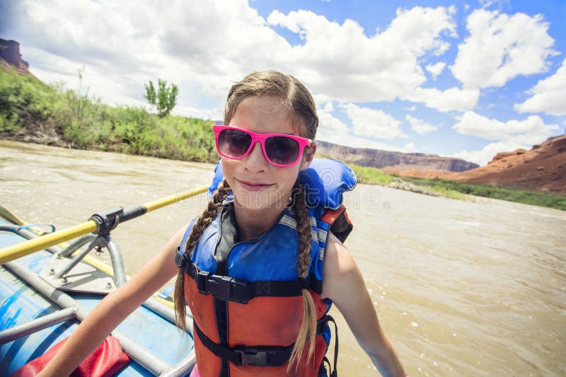 Νέο κορίτσι που έχει τη διασκέδαση σε ένα rafting ταξίδι ποταμών κάτω από τον ποταμό του Κολοράντο στοκ φωτογραφία με δικαίωμα ελεύθερης χρήσης Νέο κορίτσι που έχει τη διασκέδαση σε ένα rafting ταξίδι ποταμών κάτω από τον ποταμό του Κολοράντο στοκ φωτογραφία με δικαίωμα ελεύθερης χρήσης