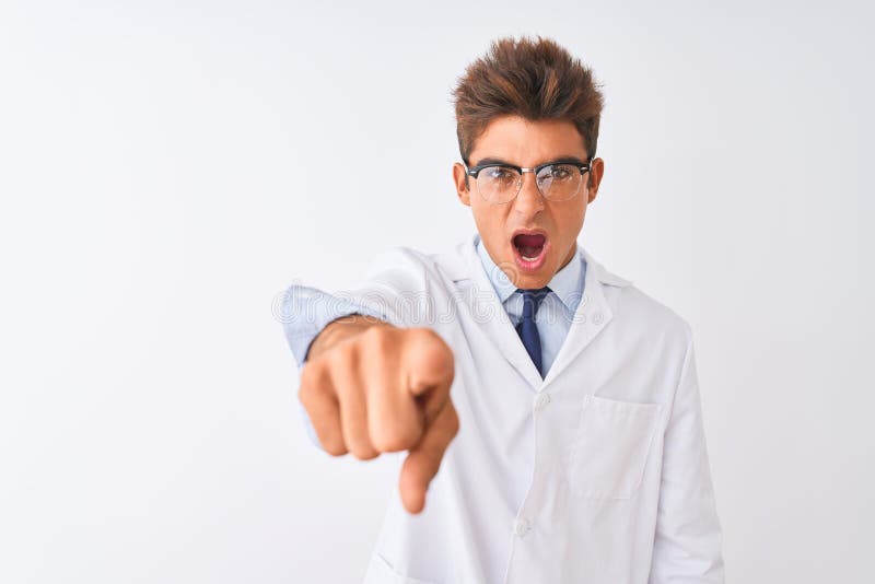 Young handsome sciencist man wearing glasses and coat over isolated white background pointing displeased and frustrated to the camera, angry and furious with you. Young handsome sciencist man wearing glasses and coat over isolated white background pointing displeased and frustrated to the camera, angry and furious with you