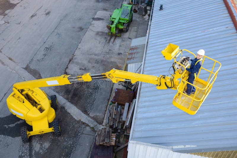 Looking down on woman in cherry picker cherry. Looking down on woman in cherry picker cherry