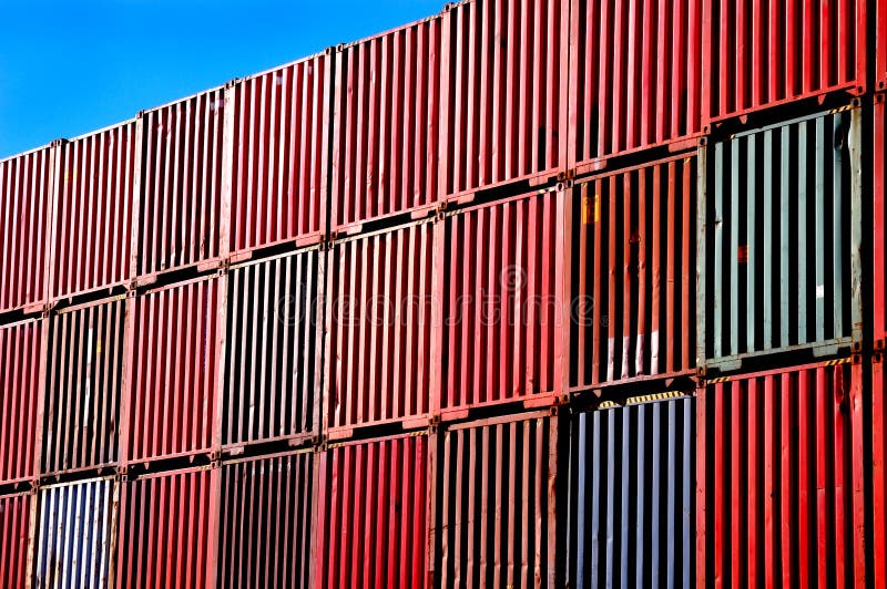 A picture of shipping containers, stacked up high in a port. A picture of shipping containers, stacked up high in a port.