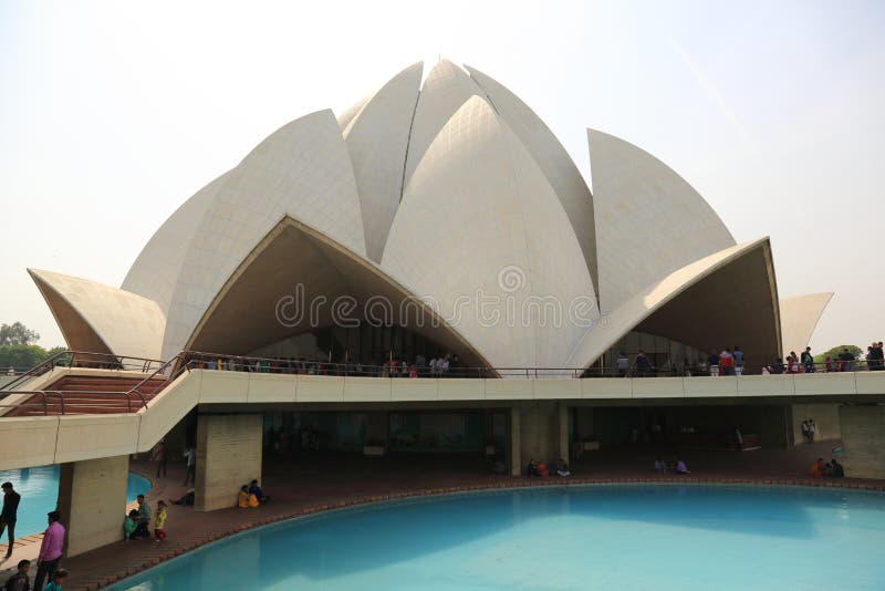 The Lotus Temple, located in New Delhi, India, is a Bahá'í House of Worship completed in 1986. Notable for its flowerlike shape, it serves as the Mother Temple of the Indian subcontinent and has become a prominent attraction in the city. The Lotus Temple has won numerous architectural awards and been featured in hundreds of newspaper and magazine articles. Like all Bahá'í Houses of Worship, the Lotus Temple is open to all, regardless of religion or any other qualification. The building is composed of 27 free-standing marble-clad petals arranged in clusters of three to form nine sides, with nine doors opening onto a central hall with height of slightly over 40 metres and a capacity of 2,500 people. A 2001 CNN report referred to it as the most visited building in the world. The Lotus Temple, located in New Delhi, India, is a Bahá'í House of Worship completed in 1986. Notable for its flowerlike shape, it serves as the Mother Temple of the Indian subcontinent and has become a prominent attraction in the city. The Lotus Temple has won numerous architectural awards and been featured in hundreds of newspaper and magazine articles. Like all Bahá'í Houses of Worship, the Lotus Temple is open to all, regardless of religion or any other qualification. The building is composed of 27 free-standing marble-clad petals arranged in clusters of three to form nine sides, with nine doors opening onto a central hall with height of slightly over 40 metres and a capacity of 2,500 people. A 2001 CNN report referred to it as the most visited building in the world.