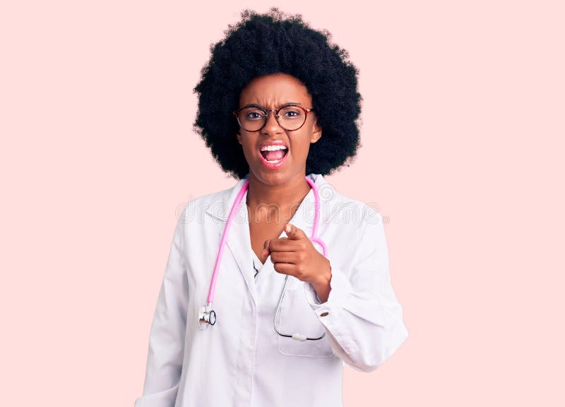 Young african american woman wearing doctor coat and stethoscope pointing displeased and frustrated to the camera, angry and furious with you. Young african american woman wearing doctor coat and stethoscope pointing displeased and frustrated to the camera, angry and furious with you