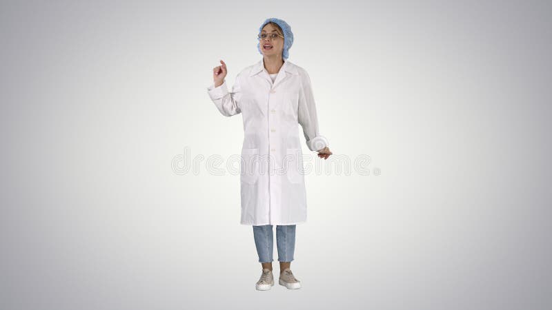 Full length shot. Young doctor woman talking to camera in very emotional way on gradient background. Professional shot in 4K resolution. 006. You can use it e.g. in your commercial video, business, presentation, broadcast. Full length shot. Young doctor woman talking to camera in very emotional way on gradient background. Professional shot in 4K resolution. 006. You can use it e.g. in your commercial video, business, presentation, broadcast