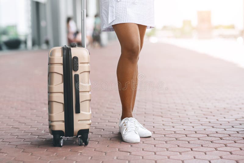 Young black woman with suitcase waiting taxi at airport, free space. Young black woman with suitcase waiting taxi at airport, free space