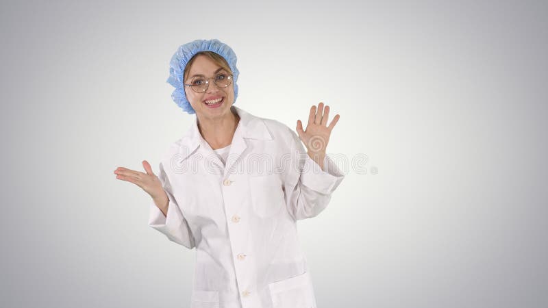 Medium shot. Geek young blonde doctor woman talking to camera on gradient background. Professional shot in 4K resolution. 006. You can use it e.g. in your commercial video, business, presentation, broadcast. Medium shot. Geek young blonde doctor woman talking to camera on gradient background. Professional shot in 4K resolution. 006. You can use it e.g. in your commercial video, business, presentation, broadcast