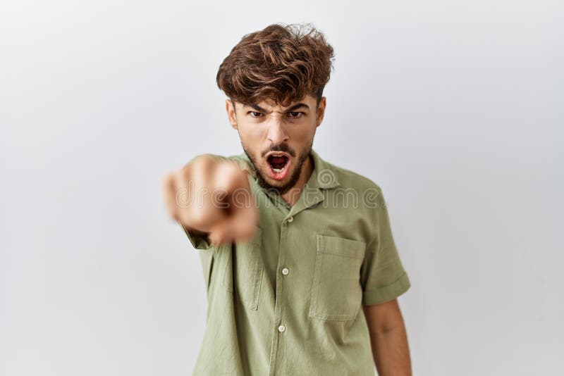 Young arab doctor man standing over isolated background pointing displeased and frustrated to the camera, angry and furious with you. Young arab doctor man standing over isolated background pointing displeased and frustrated to the camera, angry and furious with you