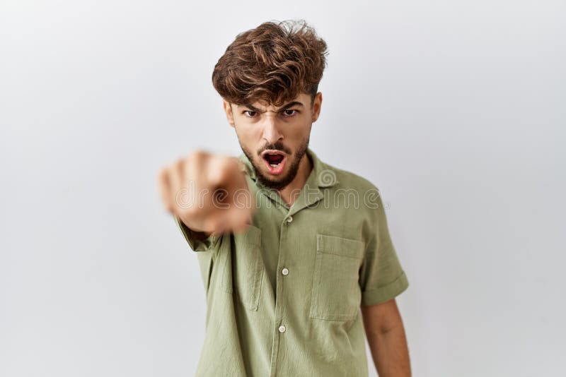 Young arab doctor man standing over isolated background pointing displeased and frustrated to the camera, angry and furious with you. Young arab doctor man standing over isolated background pointing displeased and frustrated to the camera, angry and furious with you